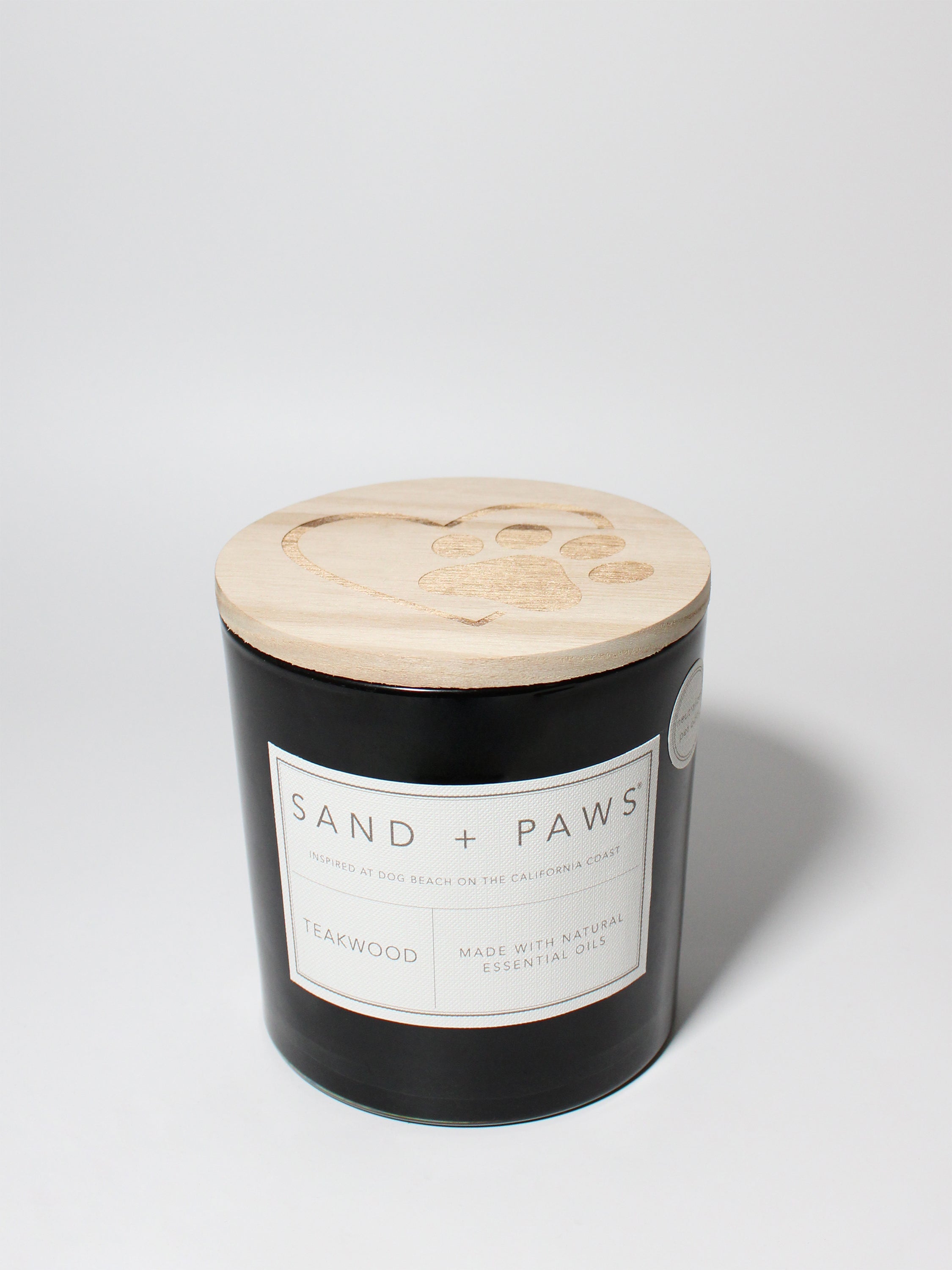 Sand + Paws Teakwood 21 oz scented candle Black vessel with Paw in Heart lid