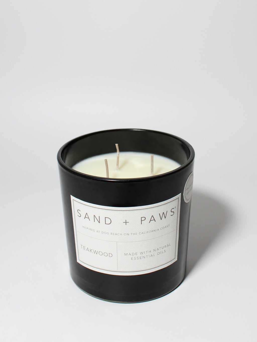 Sand + Paws Teakwood 21 oz scented candle Black vessel with Paw in Heart lid